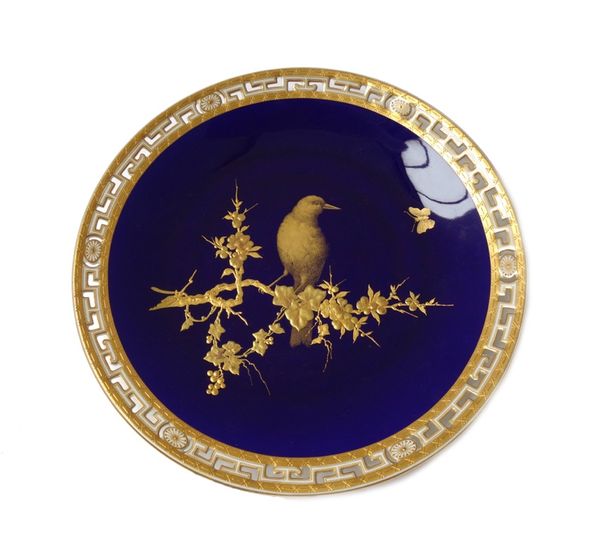 A Minton bone china blue ground pierced plate, circa 1870, painted in gilding with a bird perched on raised and tooled gilt flowering branches against
