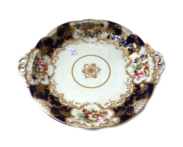 A Coalport porcelain part service, mid 19th century, painted with a central gilt medallion inside a deep blue and gilt border reserved with flower pan