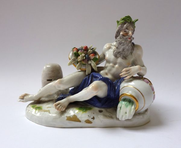 A Meissen figure of a river god, late 19th/early 20th century, emblematic of Summer, modelled recumbent against an upturned urn, and holding a cornuco