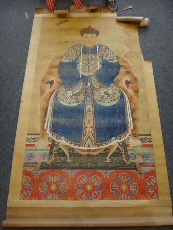 A large Chinese ancestor portrait scroll on silk, laid onto paper,  painted with an official wearing blue robes with dragon roundels, seated  on a thr