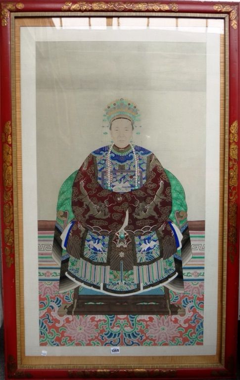 A Chinese ancestor portrait, 19th century, gouache and gilding on paper, painted with a seated woman in dragon robe with a silver pheasant badge of a