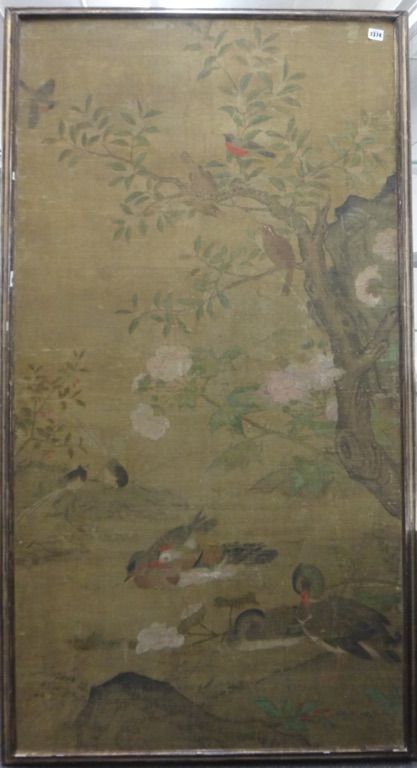 A large Chinese silk panel, 18th century, painted with birds perched in flowering branches above ducks swimming below,  145cm. by 75cm., framed.