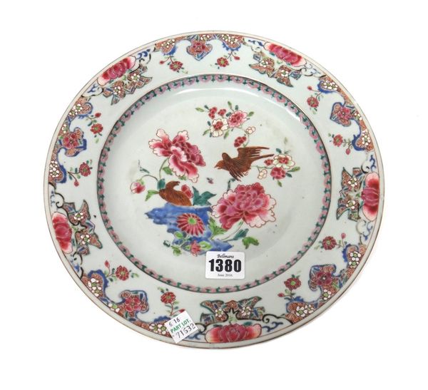 A Chinese famille-rose plate, Qianlong, painted in the centre with two birds amongst flowering shrubs and blue rocks, 27cm.diameter.