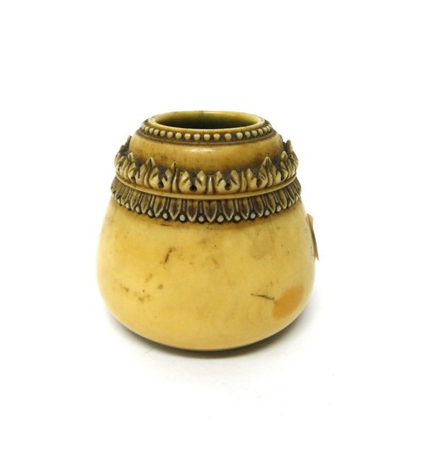 An Indian ivory inkwell, 19th century, of conical form, carved in high relief with a band of acanthus beneath a beaded rim, 7cm.high.