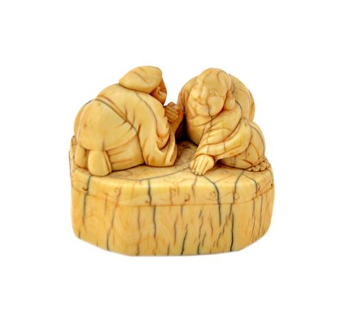 A Japanese ivory netsuke of Ebisu and Hotei arm wrestling, possibly 18th century, each carved kneeling on an octagonal base, unsigned, 4cm.wide.  Illu
