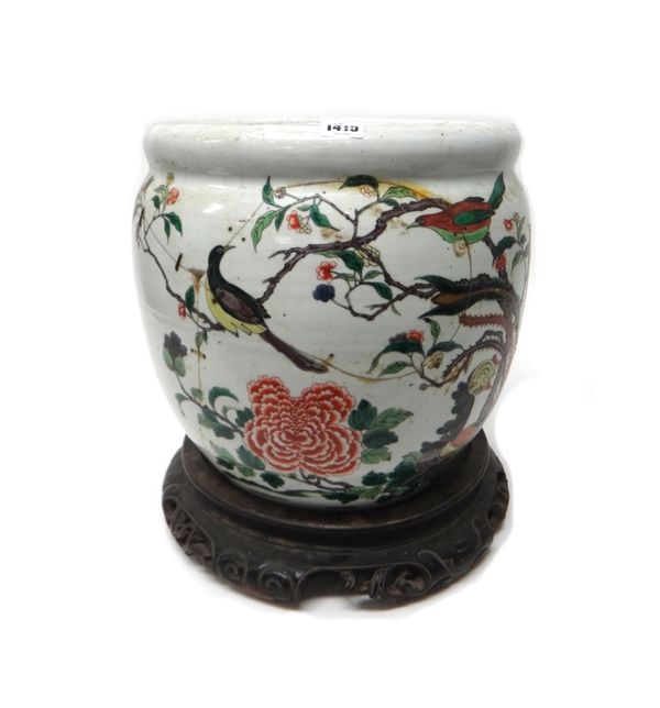 A Chinese famille-verte jardiniere, painted with birds in flowering branches, (a.f), 34cm. high. wood stand.