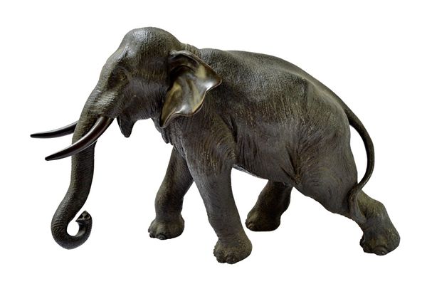 A Japanese bronze figure of a striding elephant by Genryusai Seiya, Meiji period, signed, 25cm.high.  Illustrated