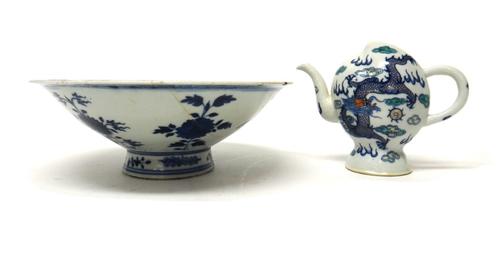 A Chinese porcelain Cadogan teapot, 20th century, the peach shaped body painted in a doucai type palette with dragons amongst cloud scrolls, blue four