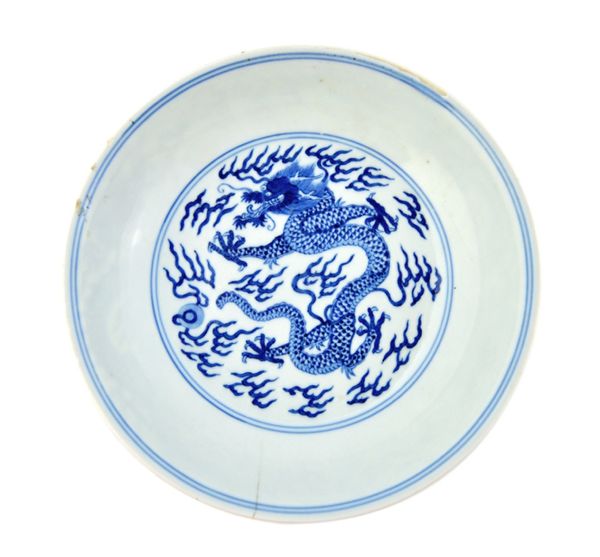 A Chinese blue and white `dragon' saucer dish, blue Jiaqing seal mark and probably of the period, painted in the centre with a five-clawed dragon amon