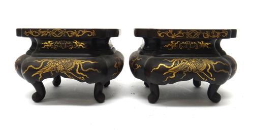 A pair of Japanese wood stands, Meiji period, each of quatrelobed form raised on four scroll supports, gilt with ho-o birds leafy branches and scrolls