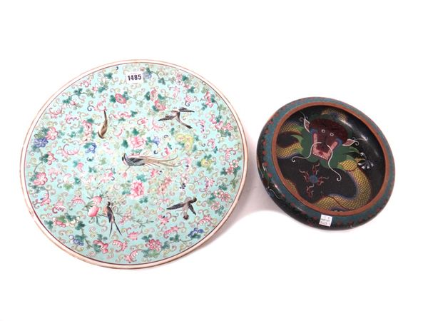 A Chinese famille-rose dish, circa 1900, painted with birds amongst flowering peony, prunus and chrysanthemum against a blue ground, 38cm.diameter; an