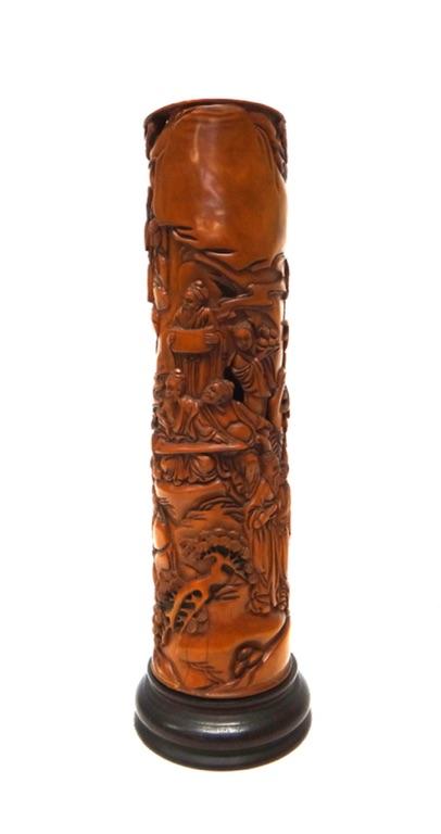 A Chinese wood parfumier, 20th century, of cylindrical form, carved and pierced with figures amongst rocks, pine and bamboo, 22.5cm.high, wood base.