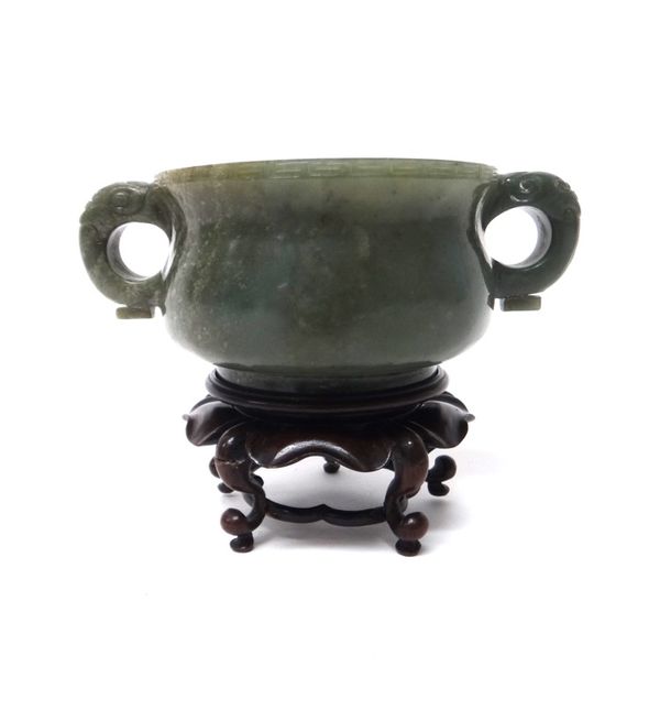 A Chinese spinach jade censer, the squat body set with animal mask handles and with a key pattern border, 14.5cm.across handles, wood stand, boxed.