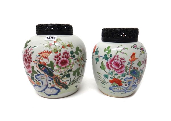 Two Chinese famille-rose ovoid jars, 19th century, each painted with a pheasant perched on a blue rock amidst flowering shrubs, (a.f), 20cm. and 22cm.