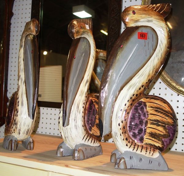 A group of three 20th century painted wooden pelicans. (3)