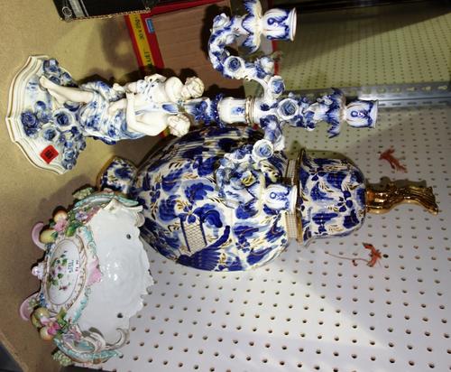 A Continental porcelain four branch candelabra, together with a Continental floral encrusted bowl, and a blue and white vase and cover. (3)