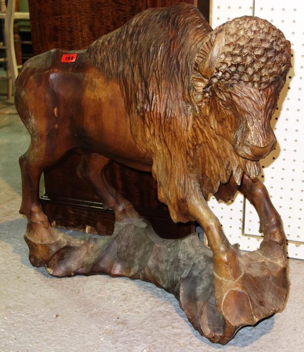 A carved hardwood model of a bison, 84cm high.
