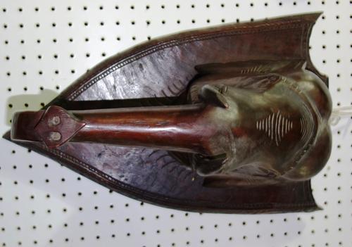A carved hardwood elephant's head mounted on a shield back plate, (1).