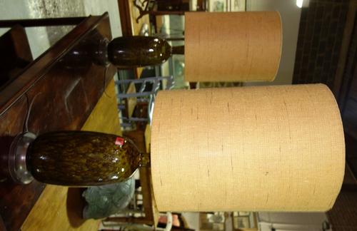 A pair of moulded green and brown pottery lamp bases. (2)