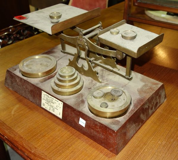 A large set of early 20th century brass postal scales, and a 19th century set of scales. (2)