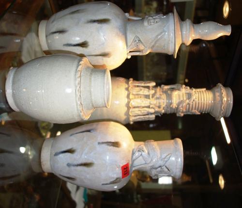 A large Chinese funerary vase decorated with a dragon and immortals, together with a pair of funerary vases and another lidded funerary vase. (4)