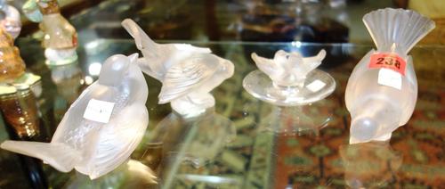 A group of three Lalique glass models of songbirds and a Lalique pin dish moulded with a pair of doves (a.f). (4)
