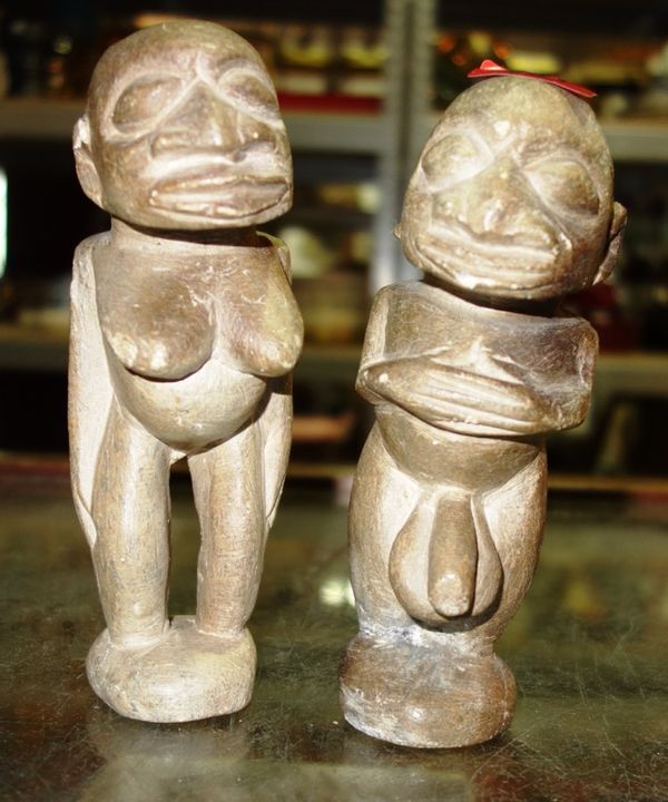 Two African carved stone fertility figures and a carved oak panel. (3)