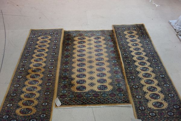 Three brown Pakistan Bokhara rugs., (3).