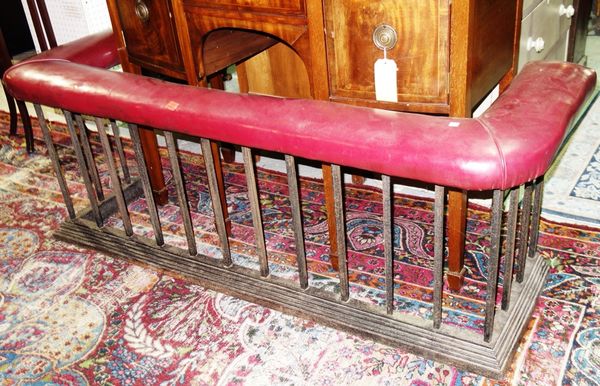 A wrought iron and red leather club fender, 162cm wide x 62cm deep.