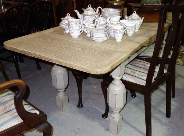 A 20th century oak draw leaf dining table, with grey painted base, 199cm wide extended.