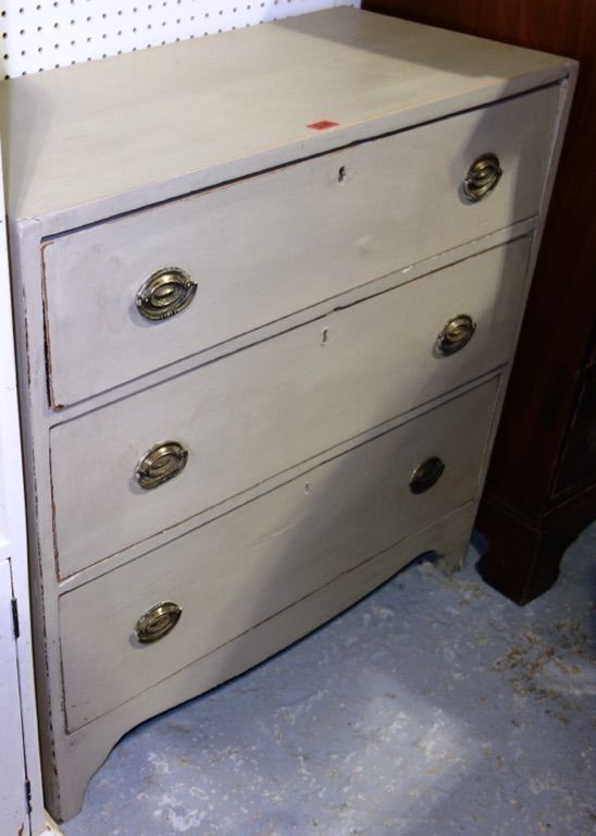 A grey painted chest of three long drawers, on bracket feet, 82cm wide.