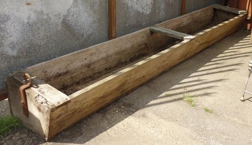 A large elm animal food trough, 305cm long.