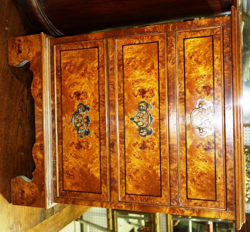 A 20th century oak three drawer bedside chest and a similar walnut chest. (2)