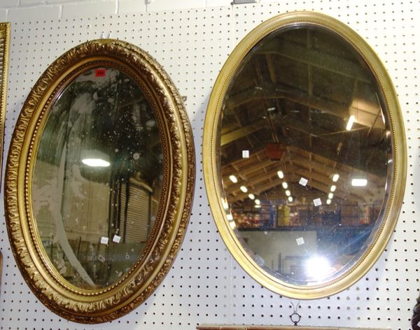 An oval gilt gesso wall mirror, and another oval gilt mirror, approx 59cm x 84cm (2)