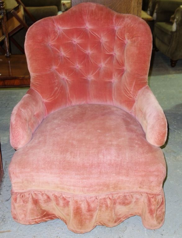 A mahogany framed pink upholstered button back nursing chair.