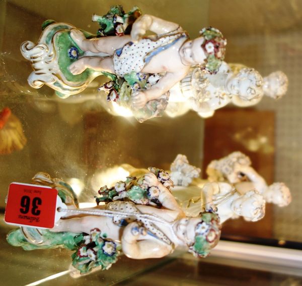 A pair of Derby porcelain cherub figures, late 18th century, on gilt scroll bases, together with four further similar white glazed figures (a.f), 12.5