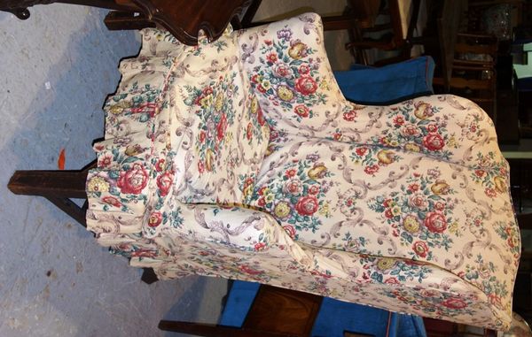 An 18th century style wing back upholstered armchair.