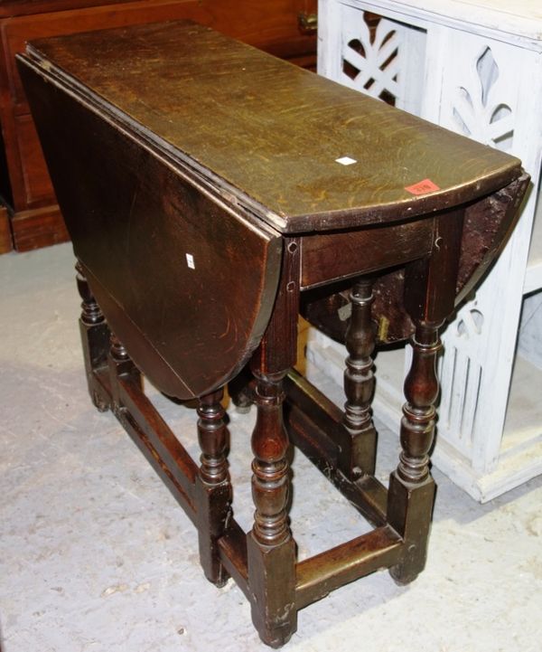 A 19th century oak drop flap dining table, 91cm wide.