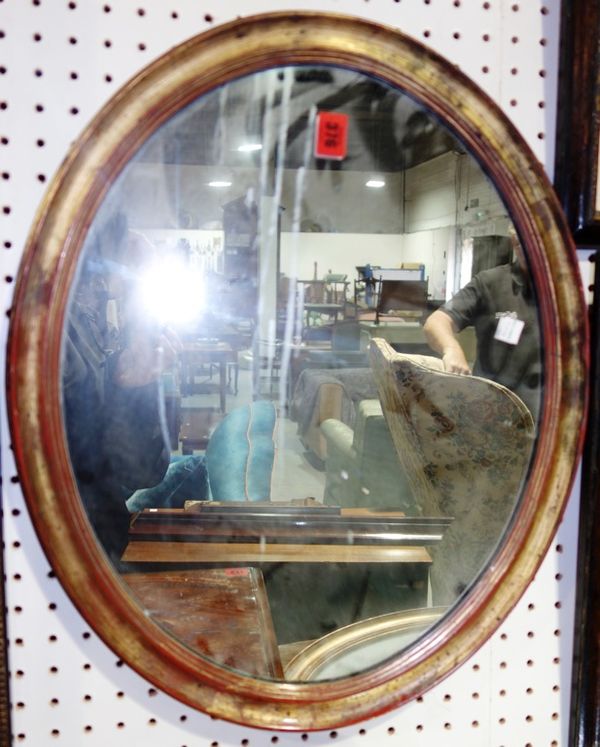 A pair of gilt decorated oval wall mirrors, 46cm wide.  (2)
