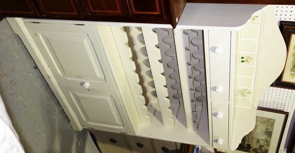A 20th century white painted side unit with pair of drawers, pair of cupboards and integral wine rack, 101cm wide.