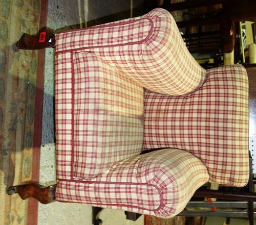 An early 20th century child's armchair on squat cabriole supports.