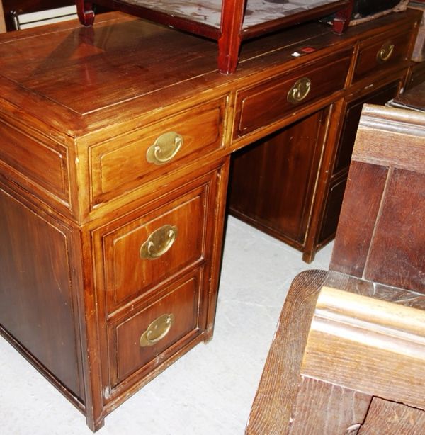A 20th century Chinese hardwood pedestal desk with seven drawers about the knee, 147cm wide, together with a two drawer filing unit, 46cm wide.