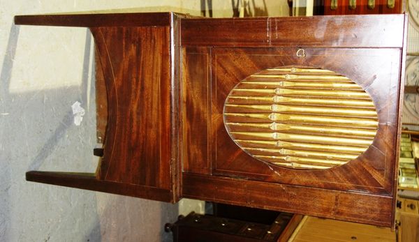 A mahogany speaker cupboard on tapering square supports, with gilt organ pipe mounted door, 61cm wide.