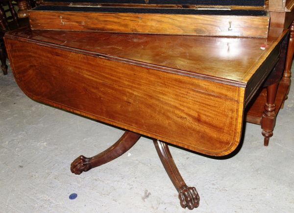 A George III satinwood banded mahogany drop flap centre table, on four downswept supports and lions paw feet, 112cm wide.