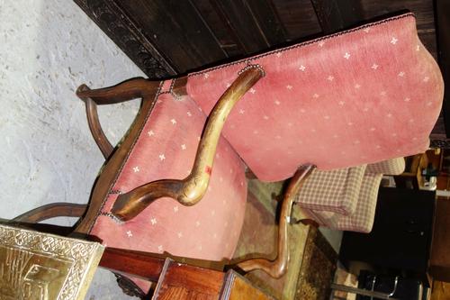 A 19th century Continental walnut framed open armchair, with serpentine seat on scroll supports, united by shaped 'X' frame stretcher.
