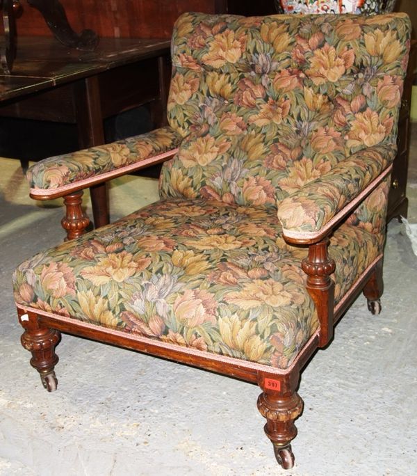 A 19th century oak framed open easy armchair on turned and fluted supports.
