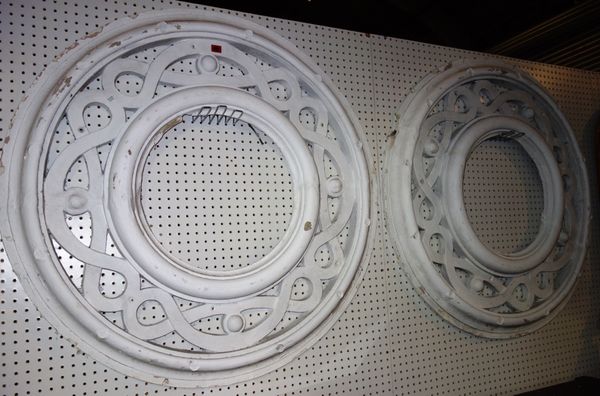 A pair of white painted plaster roundels. (2)