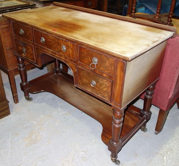 An early 20th century mahogany dressing table, with shaped platform undertier, 109cm wide