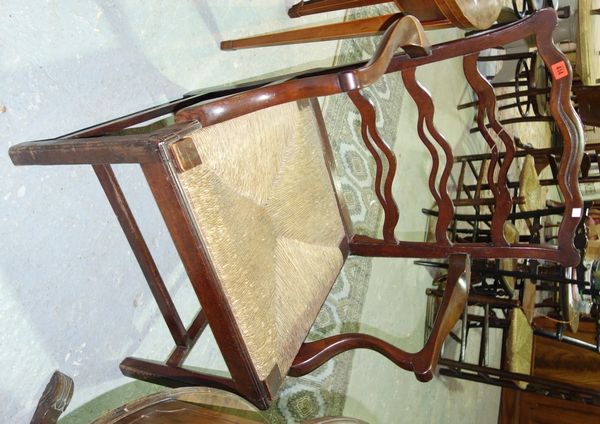 A 19th century mahogany wavy ladder back carver chair.