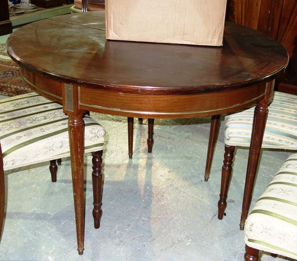 A French mahogany extending dining table, with fold over semi elliptic top, (the leaves lacking).